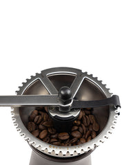 Peugeot | Kronos Coffee Mill, 7.5 inches, featuring a top view of the metal crank handle and adjustment ring, with coffee beans in the hopper ready for grinding.