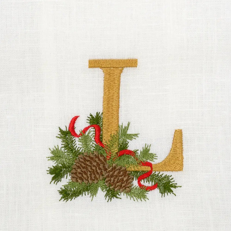 Arte Italica & Crown Linen Designs Winter Pine Monogram Towel with embroidered gold “L” and winter sprig motif, enhancing elegance for kitchen or bathroom.