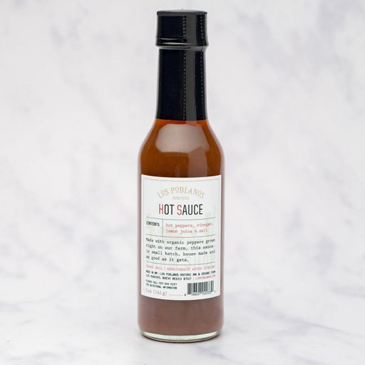 Los Poblanos | Hot Sauce: 5 oz bottle of small-batch, farm-made hot sauce with organic peppers. Ideal for enhancing meals with just-right heat and zesty tang.