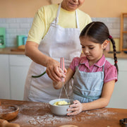 Woman using Lamson | Vintage Mini Avocado + Spud Masher in a kitchen, demonstrating its compact design and efficiency for mashing in small bowls.
