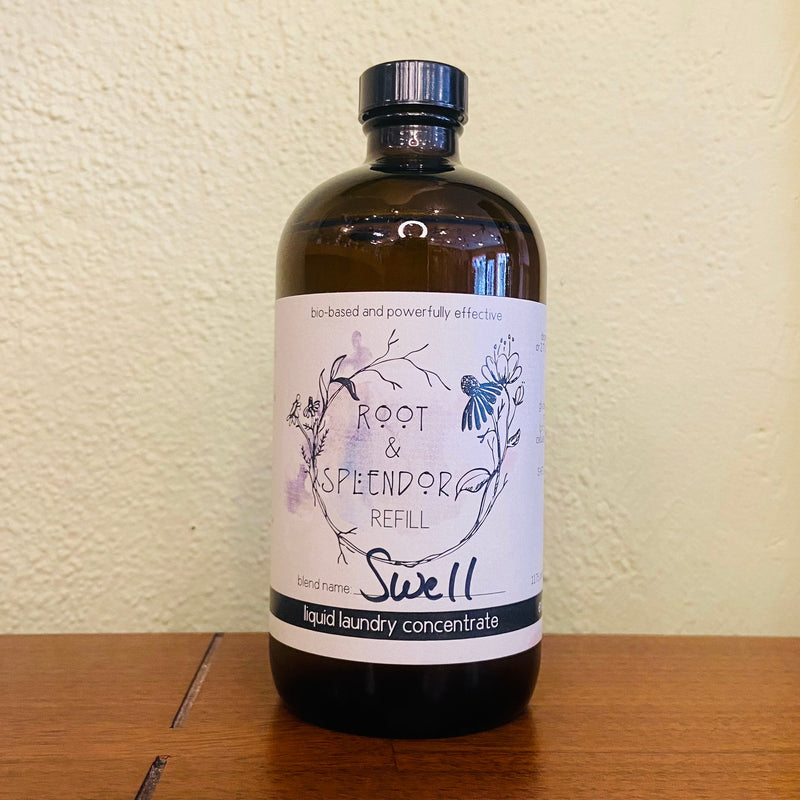 Root & Splendor | Laundry Concentrate 16 oz Glass Bottle - Swell, in sustainable packaging, offering an eco-friendly, ultra-concentrated formula with lemongrass, bergamot, and cedarwood infusion.