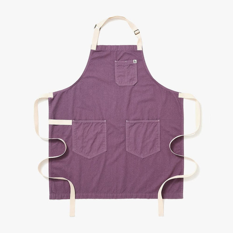 Hedley & Bennett | Essential Garment Dyed - Lavender apron with beige neck strap, waist ties, and three pockets, crafted from sturdy fabric, ideal for culinary enthusiasts.