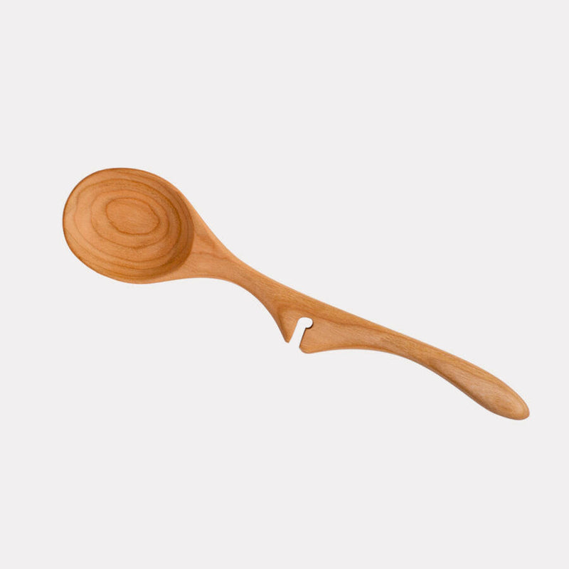 Jonathan's Cherry Wood Ladle from the Lazy Spoon® + Ladle Collection, designed for mess-free serving, elegantly rests on pots, ideal for culinary enthusiasts.
