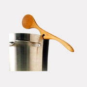 Jonathan's Spoons | Lazy Spoon® + Ladle Collection features a cherry wood ladle with a notched handle resting on a stainless-steel pot rim for practical, mess-free cooking.