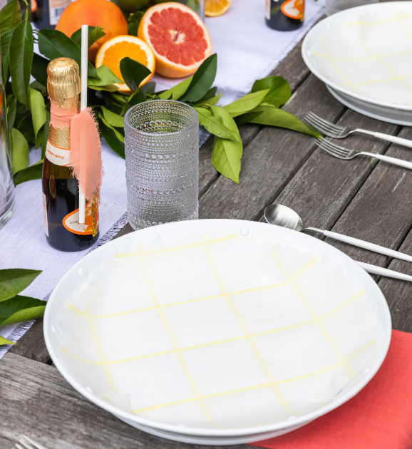 Plate & Pattern | Lemon Chiffon Original Flat Plate Liners on a table with dishware and citrus fruits, showcasing their versatility for trays and platters.