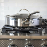 Hestan Provisions | Stainless Steel Lids Dome, 14 on a gas range burner, showcasing its polished handle and snug fit for optimal cooking performance.
