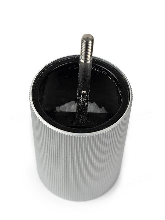 Peugeot | Line Salt Mill Aluminum + Beechwood, Natural, 7 inches, showcasing its ribbed aluminum body and grind mechanism packed with salt crystals.