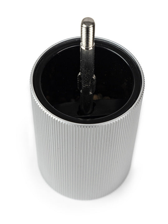 Peugeot Line Pepper Mill with natural wood head and striated aluminum body, showcasing its adjustable grind setting, ideal for enhancing kitchen elegance.