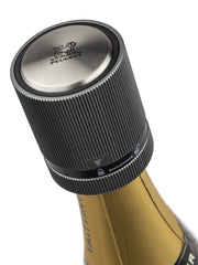 Close-up of a champagne bottle highlighting Peugeot | BULK DISPLAY Line Bottle Stoppers - Carbon, ideal for sealing and preserving wines or spirits.