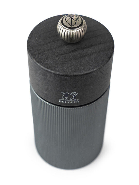 Peugeot | Line Pepper Mill Aluminum + Beechwood, Carbon, 4.75 inches features ridged design with Peugeot lion logo and adjustable knob, perfect for culinary enthusiasts.