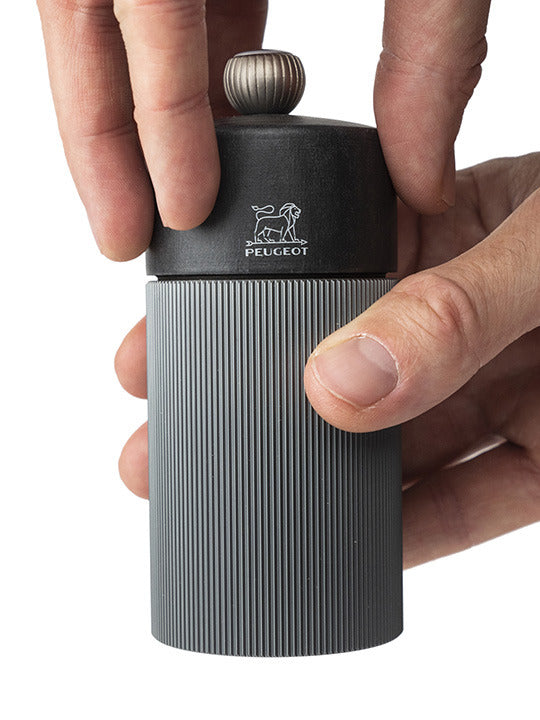 Peugeot | Line Pepper Mill Aluminum + Beechwood, Carbon, 4.75 inches – featuring a ribbed gray body, black top, and Peugeot lion logo, perfect for precise seasoning.