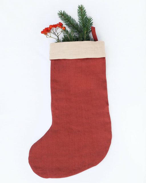 MagicLinen Linen Christmas Stocking in Clay Red, handcrafted from natural linen with a double layer, featuring a loop for hanging, perfect for your holiday decor.
