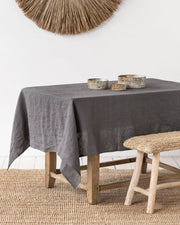MagicLinen forest green linen tablecloth, 59 x 98 inches, with simple seam finish, perfect for versatile dining settings.