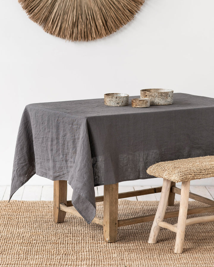 MagicLinen forest green linen tablecloth, 59 x 98 inches, with simple seam finish, perfect for versatile dining settings.