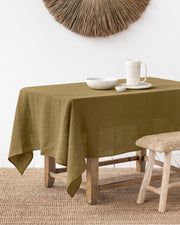 MagicLinen forest green linen tablecloth, 59 x 98 inches, with a simple seam finish, ideal for diverse dining settings, from casual to formal occasions.