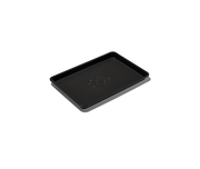 Great Jones | Little Sheet - Pepper, a nonstick quarter-sized baking tray with holes, ideal for small ovens, shown in a close-up emphasizing its design and functionality.