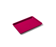 Great Jones | Little Sheet - Pepper, a quarter-sized nonstick baking tray, ideal for small batches, showcased on a black background.