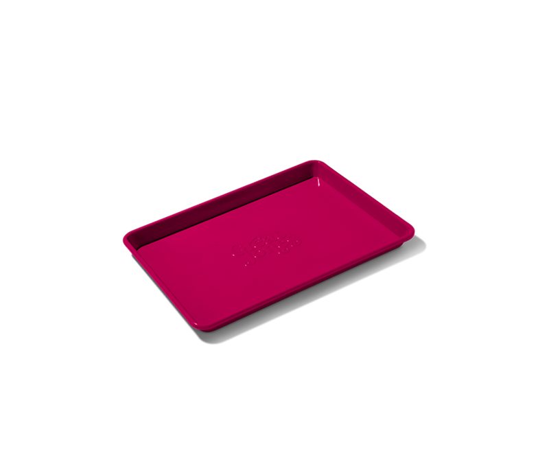 Great Jones | Little Sheet - Pepper, a quarter-sized nonstick baking tray, ideal for small batches, showcased on a black background.