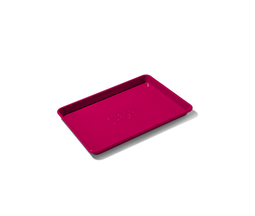 Great Jones | Little Sheet - Pepper, a quarter-sized nonstick baking tray, ideal for small batches, showcased on a black background.