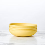 Fable New York | Bamboo Plates & Dinnerware - Low Bowl (Set of 4) - Midnight Moon, featuring a stack of durable, eco-friendly yellow bowls made from bamboo fiber.