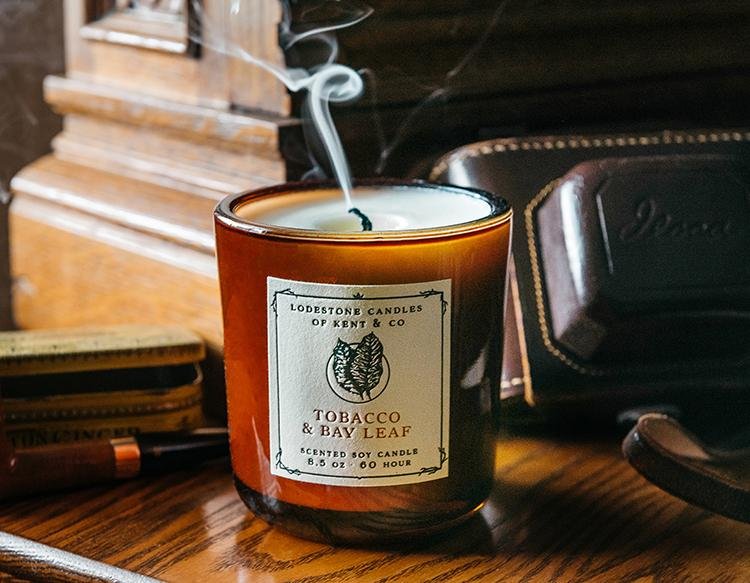 Lodestone Luxury Soy Candle - Tobacco & Bay Leaf in a glass jar, showcasing its artisanal label, perfect for enhancing any kitchen or dining space.