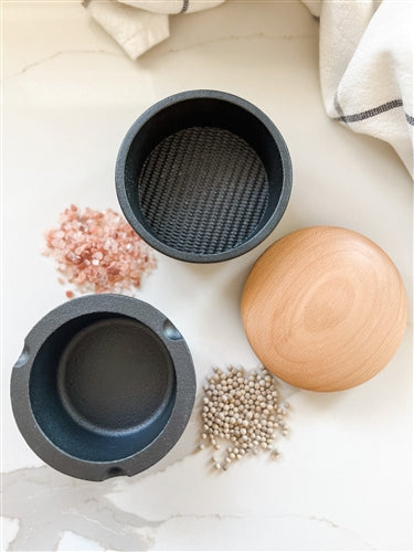 Frieling XL Spice Buddy cast iron bowl with a beech wood lid, displayed with a pile of pink salt, ideal for kitchen spice storage.