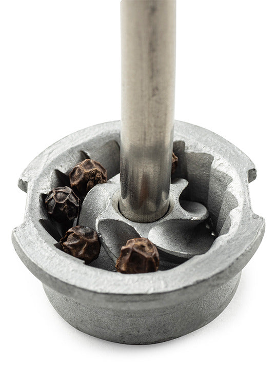 Pepper mill's metal grinding burr with trapped peppercorns, highlighting Peugeot Elis Sense's advanced design and precise grind control, perfect for culinary enthusiasts.