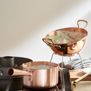 Mauviel | M'PASSION Copper Sugar Pan on stove, ideal for precise heat control in pastry tasks, showcased for Athens Cooks' curated kitchenware collection.