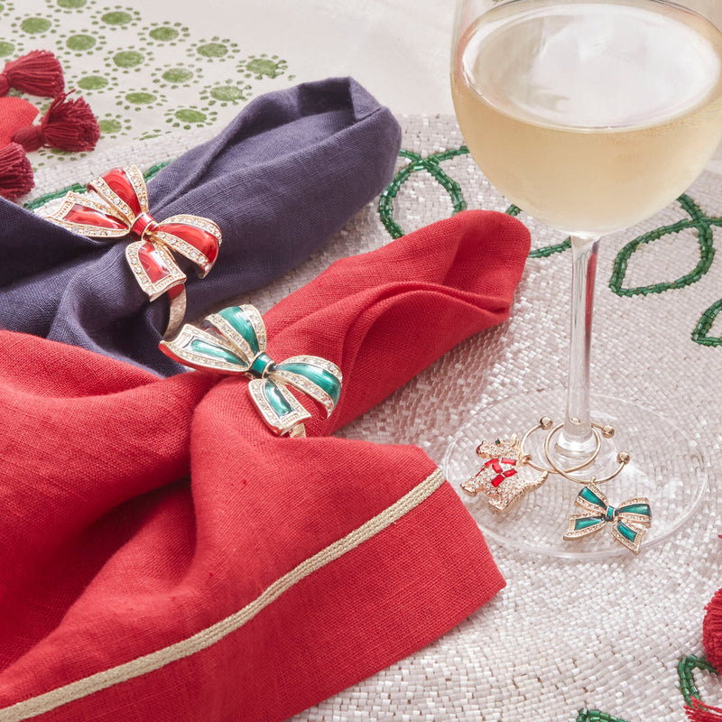 Joanna Buchanan Christmas Wine Charms adorn a wine glass, featuring a festive design perfect for holiday gatherings, offered by Athens Cooks.