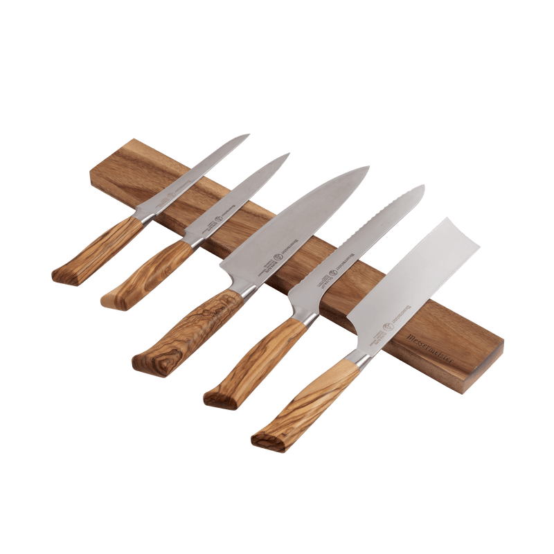 Messermeister Acacia Magnetic Knife Rack with five kitchen knives displayed; stainless-steel blades, olive-wood handles, on a stylish acacia wood magnetic strip.