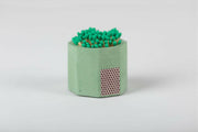 Tenn Prairie | Match Holders with Striker + Matches: Close-up of a blue concrete match holder with cork bottom, containing 70 green-tipped matches and a side striker pad.