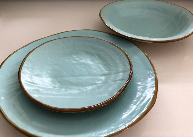 Close-up of Novita | Mediterranean Stoneware Dinner Plates - Gray, showcasing unique hand-dipped stoneware design with varied shapes and finishes, perfect for mix-and-match table settings.