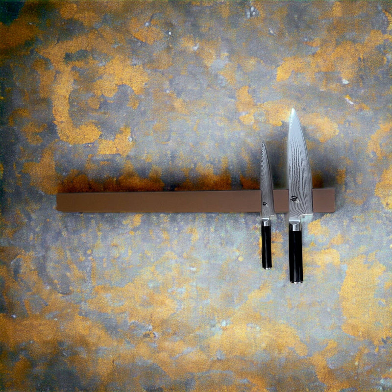 Rune-Jakobsen Design 'Leather protected' knife magnet with oak and light brown Italian leather front, showcasing its sleek design and magnetic functionality for kitchen knife storage.