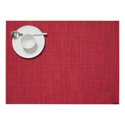 Chilewich Mini Basketweave Rectangular Placemat in Scarlet with a white plate, bowl, and spoon, showcasing its elegant texture ideal for dining settings.