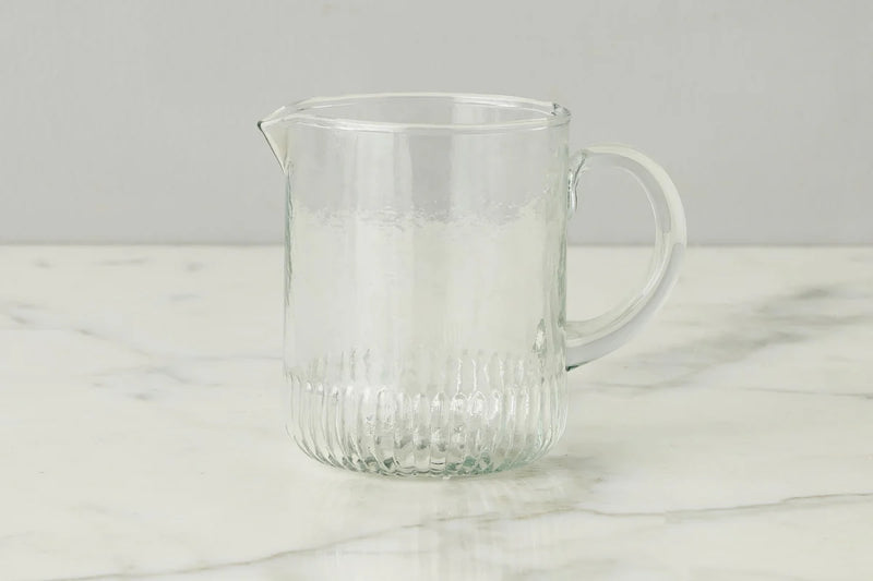 Etú HOME | Bistro Mini Jug on a marble surface, showcasing its elegant design with a graceful pour spout and sturdy handle, inspired by 1930s Depression glass.