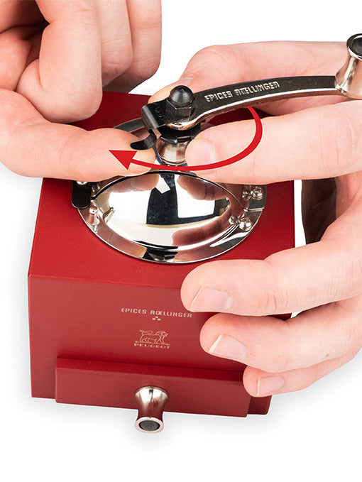 Peugeot | Roellinger Pepper Mill, Red: A hand-cranked spice mill with a red wooden body, chrome top, and Épices Roellinger-stamped handle for grinding spices.