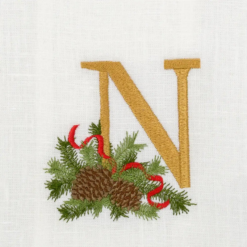 Arte Italica & Crown Linen Designs Winter Pine Monogram Towel features a gold N with pine boughs and cones, perfect for holiday elegance in kitchens or bathrooms.