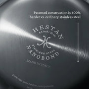 Close-up of Hestan NanoBond 8.5 Titanium Skillet base, highlighting patented construction claims and Made in Italy branding on stainless steel surface.