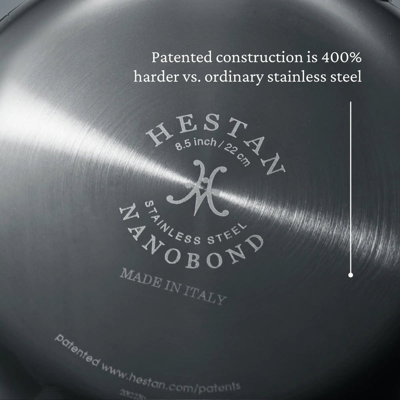 Close-up of Hestan NanoBond 8.5 Titanium Skillet base, highlighting patented construction claims and Made in Italy branding on stainless steel surface.