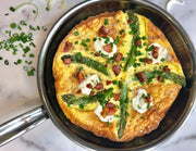 Hestan NanoBond | Cookware, 11 Titanium Skillet showcasing a frittata with asparagus, bacon, and cheese. Ergonomic handle and resilient surface ideal for culinary creations.