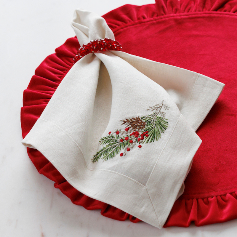 Arte Italica & Crown Linen Designs | Natale Sprig Napkin - Cream, elegantly folded with red beads, perfect for any festive table setting from Athens Cooks.
