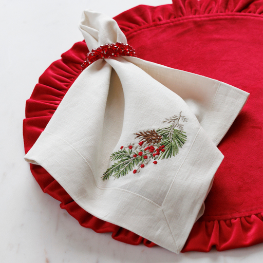 Arte Italica & Crown Linen Designs | Natale Sprig Napkin - Cream, elegantly folded with red beads, perfect for any festive table setting from Athens Cooks.