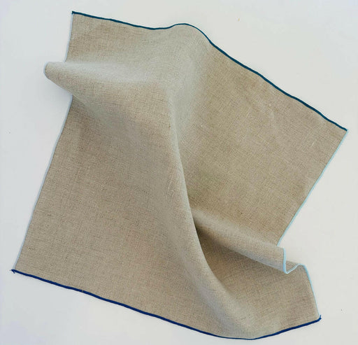 Tisch New York | Natural Linen Napkins Set of 4 - Blue Hem, neatly folded, showcasing quality fabric, perfect for enhancing dining experiences.