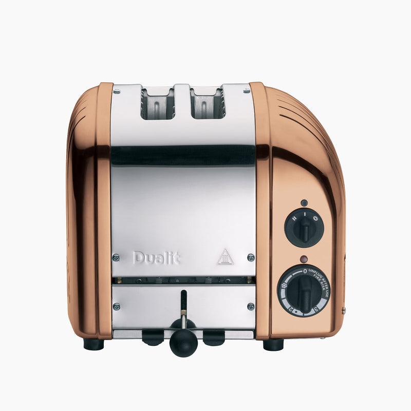Dualit | 2 Slice Classic Toaster, Copper, featuring polished metal body, rotary controls, and lever, ideal for toasting with precision and style.