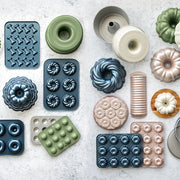 Nordic Ware | 2 Piece Puppy Love Treat Pan and Dog Treat Mix, featuring nonstick aluminum baking molds, ideal for crafting homemade dog treats.