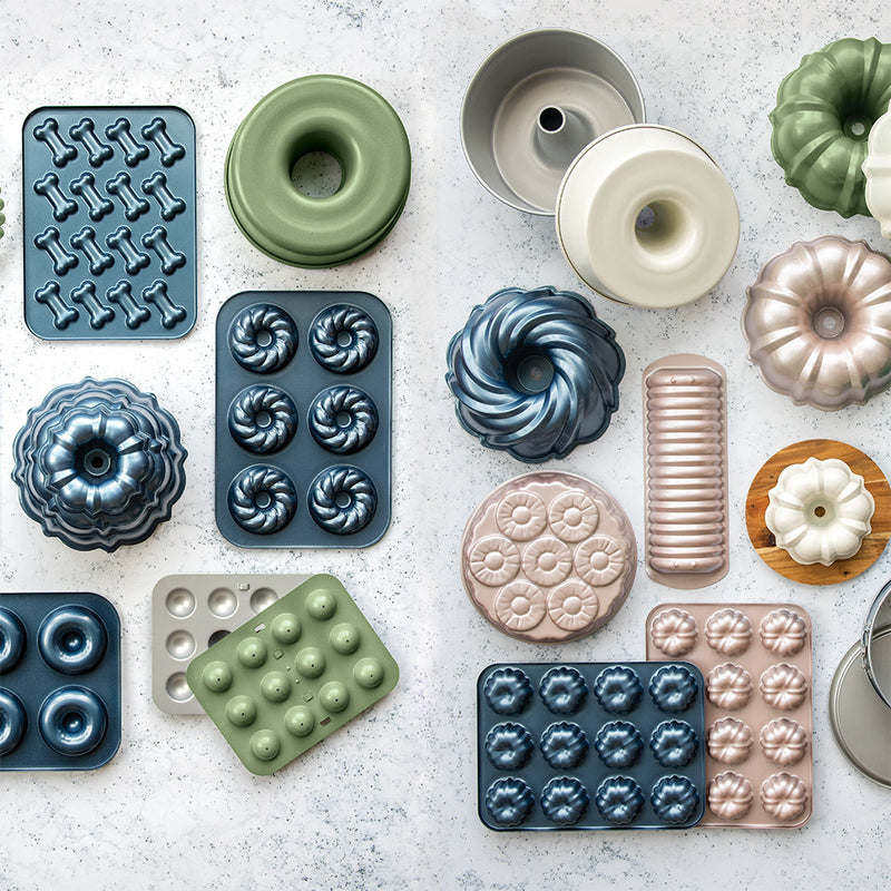 Nordic Ware | 2 Piece Puppy Love Treat Pan and Dog Treat Mix, featuring nonstick aluminum baking molds, ideal for crafting homemade dog treats.