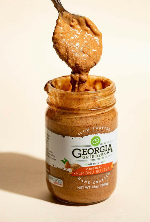Georgia Grinders | Nut Butters - Creamy Peanut Butter; close-up of almond and peanut butter jars showcasing organic, Georgia-sourced ingredients crafted for rich, savory flavors.