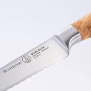 Messermeister | Oliva Elite Reverse Scalloped Utility Knife, 6 inches, featuring a serrated stainless-steel blade and elegant wood-grain handle, ideal for precise slicing tasks.