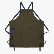 Hedley & Bennett | All Day Crossback - Olive apron features durable canvas with two large front pockets, a chest pocket, and navy-blue crossback straps.