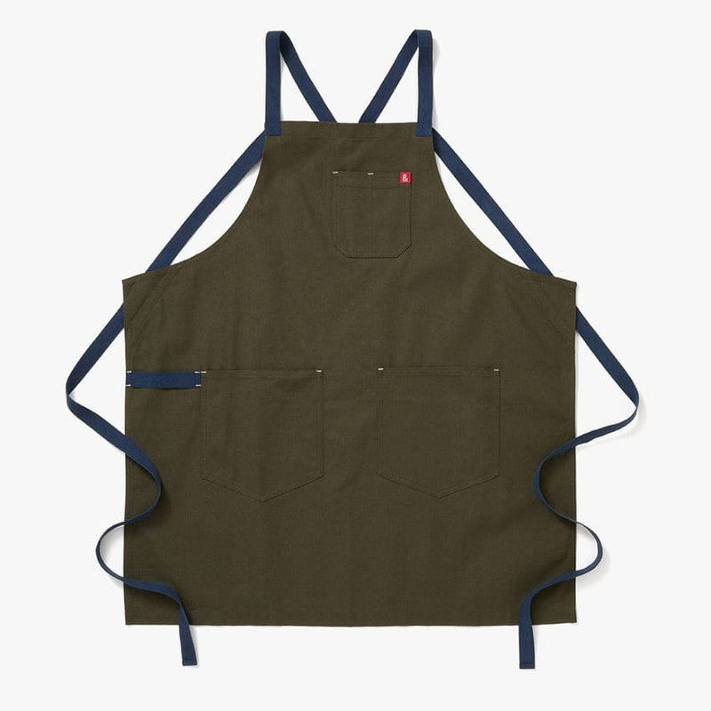 Hedley & Bennett | All Day Crossback - Olive apron features durable canvas with two large front pockets, a chest pocket, and navy-blue crossback straps.